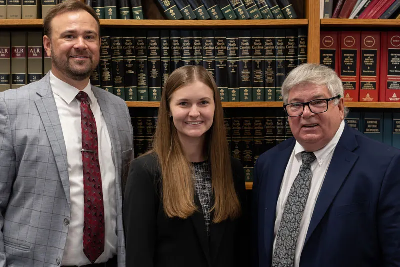 Three Hester, Grady & Hester attorneys standing together